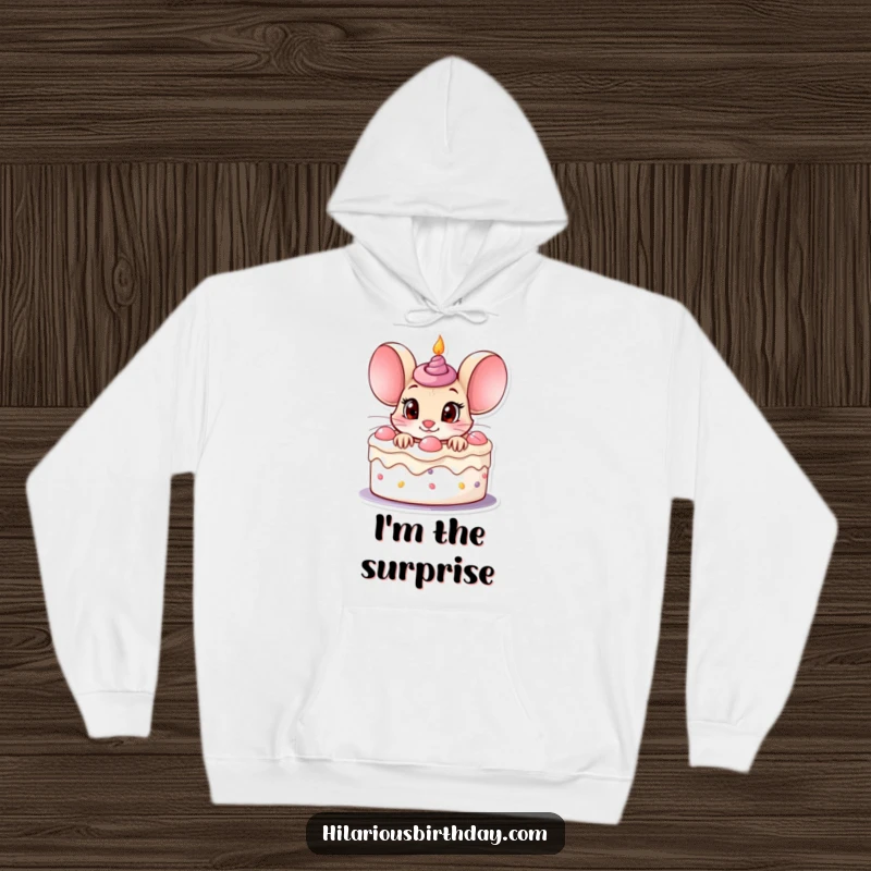 Funny curious mouse character peeking out of a birthday cake with wide eyes, featured on a warm hoodie.
