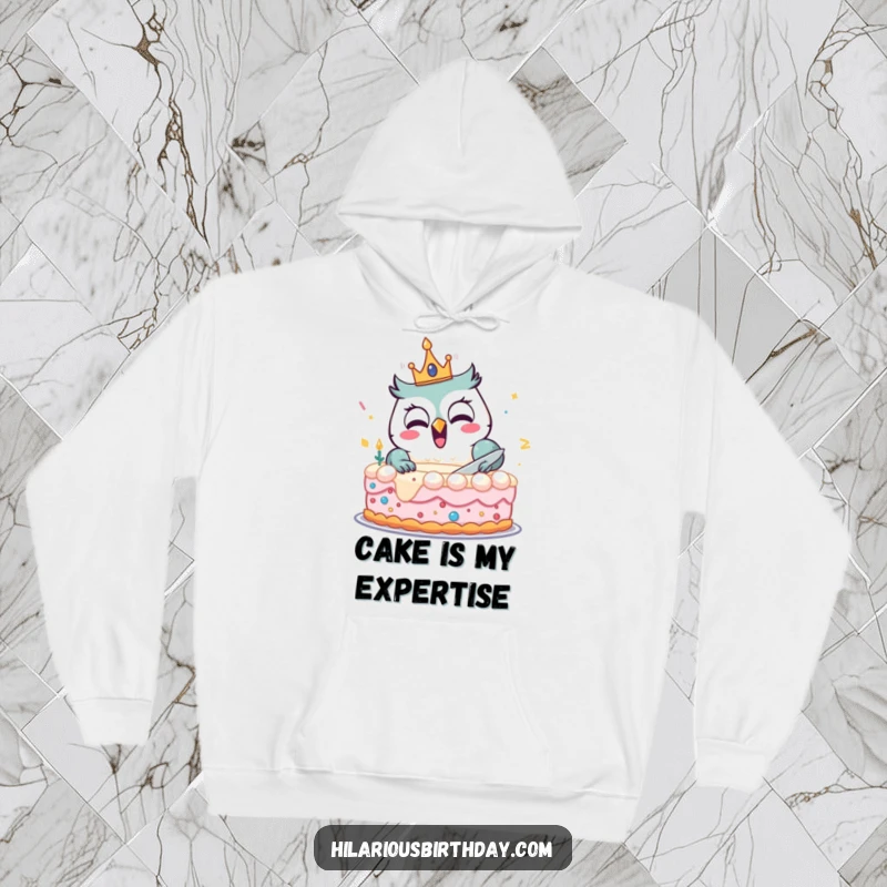 Funny hoodie with a delighted owl wearing a crown, joyfully cutting a large birthday cake, designed for cozy celebrations.