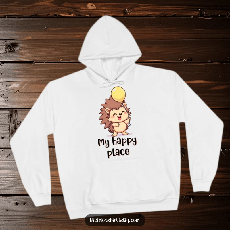Funny smiling hedgehog character excitedly grasping a floating balloon on this cozy hoodie, exuding cheerful vibes, a superb funny gift.