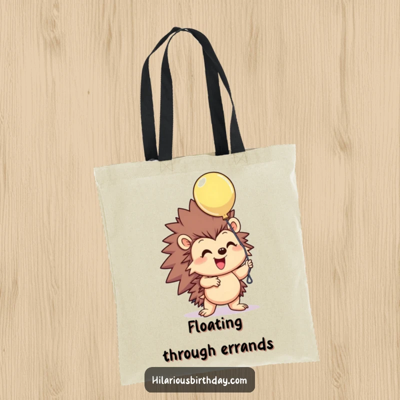 Funny smiling hedgehog character excitedly grasping a floating balloon on this durable tote bag, a humorous and delightful funny gift.