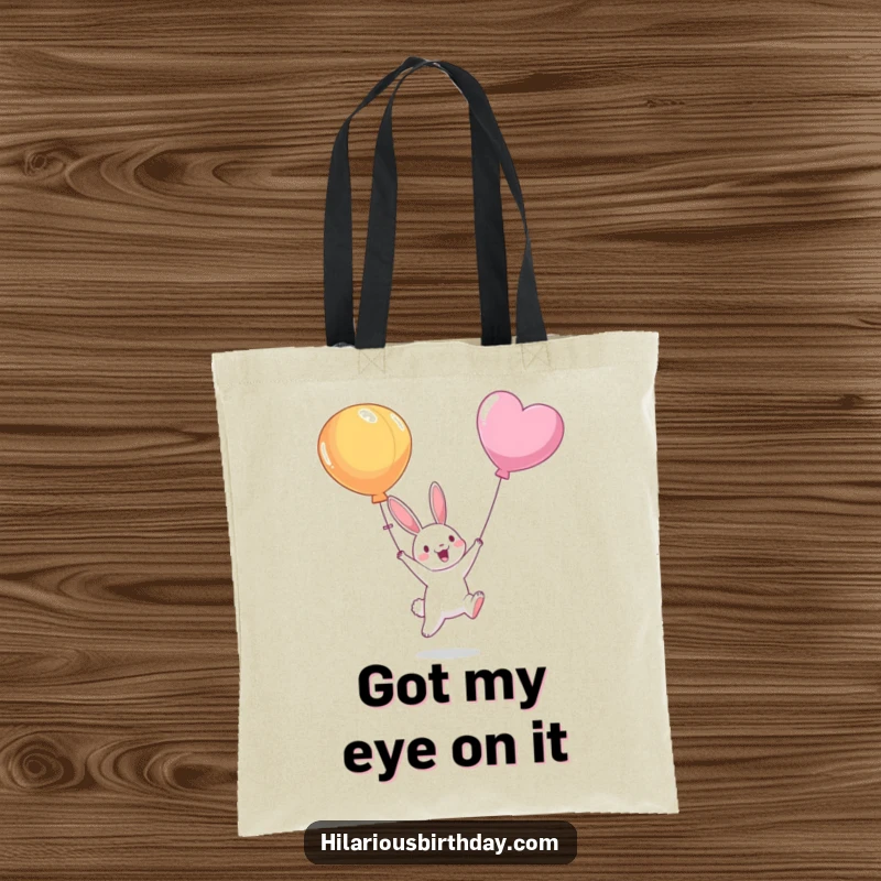 Funny tote bag displaying a smiling bunny character jumping high to reach a passing balloon, conveying optimism and pursuit of joy.